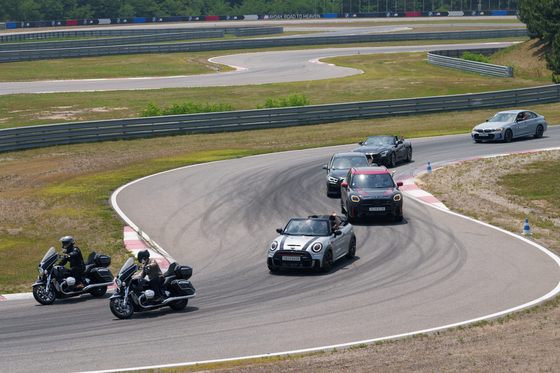 BMW and MINI cars run on a track at the automaker's driving center in Incheon on Thursday. [BMW KOREA]