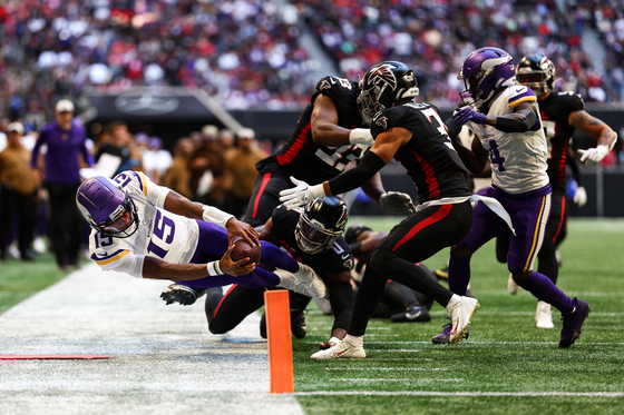 Minnesota Vikings quarterback Joshua Dobbs reaches for the pylon during the second quarter of an NFL game against the Atlanta Falcons in Atlanta on Nov. 5, 2023. This image, taken by Kevin Sabitus, topped the American Football category at the 2024 World Sports Photography Awards.  [KEVIN SABITUS]