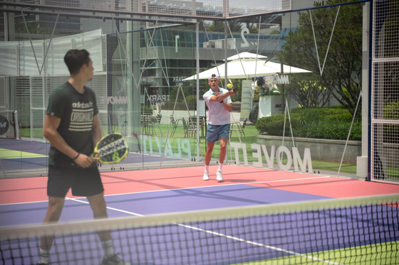 People play padel at the Mmove Padel Lounge in Yongsan District, central Seoul in May. [MMOVE]