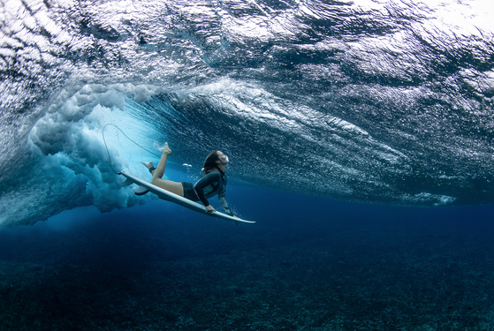 Australian surfer Olivia Ottaway dives under a wave on Aug. 19, 2023 in Teahupo'o, French Polynesia in this Aquatics category-winning image taken by Ryan Pierse. As well as this gold award, Pierse also won bronze in the Cycling category at the 2024 World Sports Photography Awards.  [RYAN PIERSE]