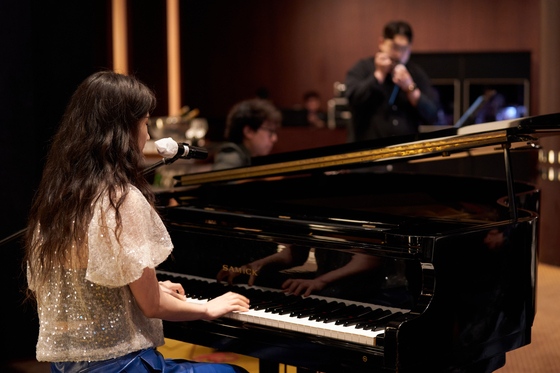 Singer-songwriter U.Bar.E, guitarist Kim Su-yu and harmonica player Lee Han-gyeol join together for a jazz performance during the Culture Communication Forum 2024 on Monday. [CICI]        