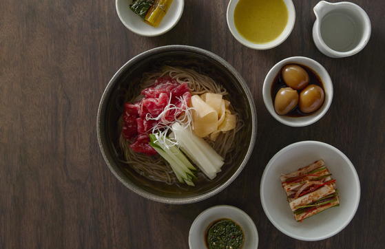 Naengmyeon (cold buckwheat noodles) and banchan (side dishes) from the newly opened Korean restaurant, Na Oh, in Singapore's Hyundai Motor Group Innovation Center. [YONHAP]