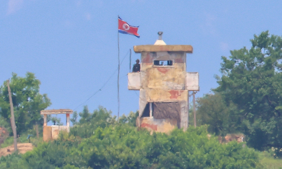 A North Korean soldier stands guard on the balcony of a watch post along the inter-Korean border across from Paju, Gyeonggi, on June 9. [YONHAP]