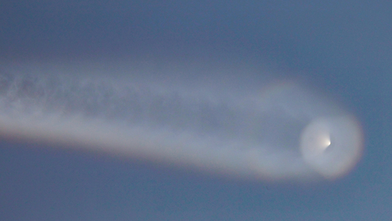 A contrail from a presumed North Korean intermediate-range ballistic missile Wednesday morning is seen over waters near Yeonpyeong Island in Incheon. [YONHAP]