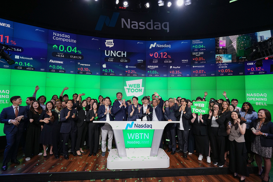 Webtoon Entertainment executives and employees pose for a photo at the bell-ringing ceremony of the company's Nasdaq listing at New York's Times Square on Thursday. [WEBTOON ENTERTAINMENT]
