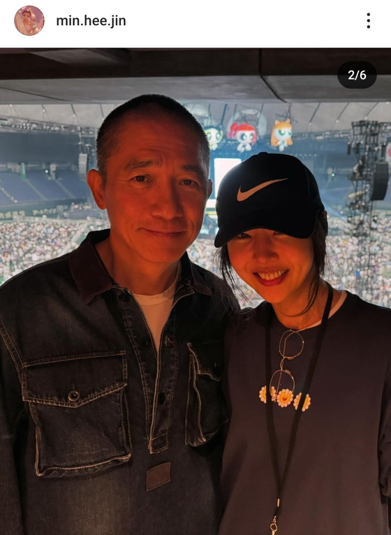 CEO of girl group NewJeans' agency ADOR, Min Hee-jin at right, poses in a picture she uploaded on her Instagram account with Hong Kong actor Tony Leung at the girl group's meet and greet on June 26. [SCREEN CAPTURE]
