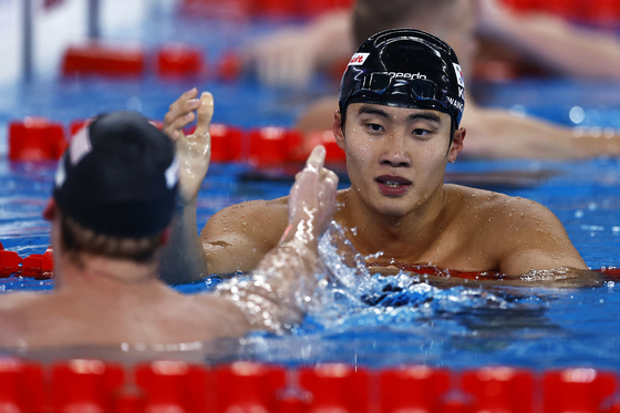 Hwang Sun-woo, right, reacts after winning the men's 200-meter freestyle final at the World Aquatics Championships in Doha, Qatar on Feb. 13. [REUTERS/YONHAP] 