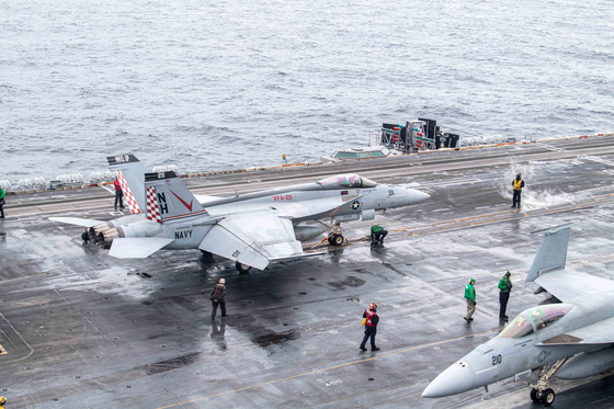 A F/A-18 Super Hornet supersonic fighter jet is on the deck of the USS Theodore Roosevelt south of Jeju Island during the trilateral Freedom Edge exercise on Friday. [U.S. NAVY]