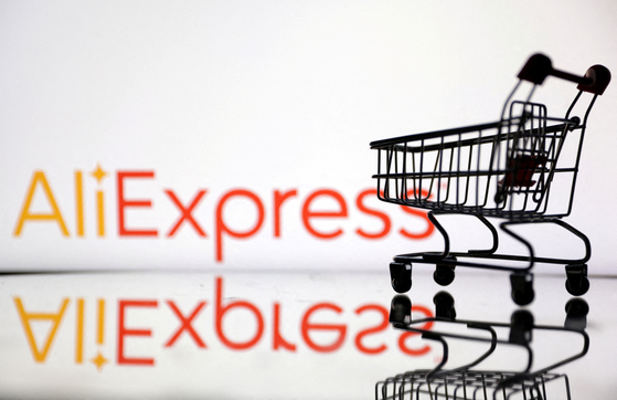A shopping trolley is seen in front of AliExpress logo. [REUTERS/YONHAP]