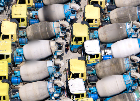 Transport vehicles for ready-mixed concrete are parked at a cement factory in Anyang, Gyeonggi, on Monday.[YONHAP]