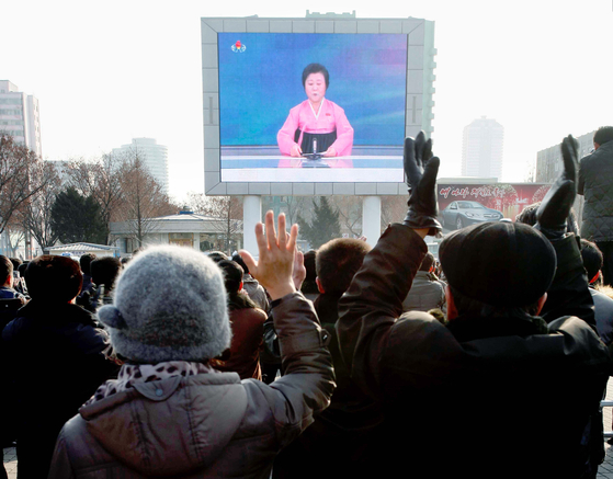 North Koreans watch a news broadcast on a video screen outside Pyongyang Railway Station in Pyongyang, North Korea on Jan. 6, 2016. [AP]