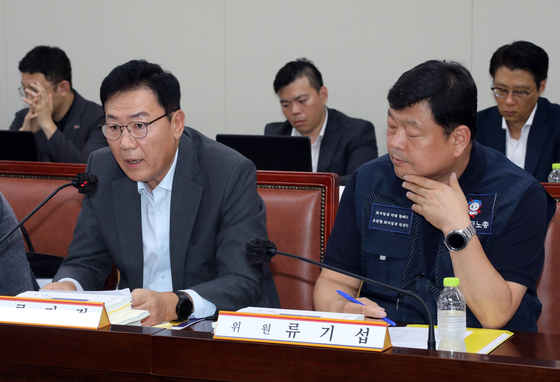 Ryu Gi-jeong, left, an executive at the Korea Enterprises Federation and a member of the Minimum Wage Commission, speaks during the commission's meeting at the government complex in the central city of Sejong on Tuesday. [YONHAP]