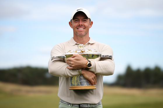 Rory McIlroy poses for a photo with the Genesis Scottish Open trophy on the 18th green after winning the tournament during Day Four of the Genesis Scottish Open at The Renaissance Club on July 16, 2023 in Scotland. [GETTY IMAGES]