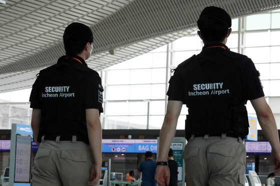 Two airport security officers patrol inside Incheon International Airport in July 1, 2020 in Incheon. [NEWS1] 