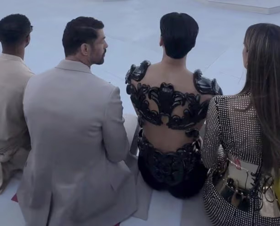 San sits on the edge of his seat the Dolce & Gabbana show [SCREEN CAPTURE]