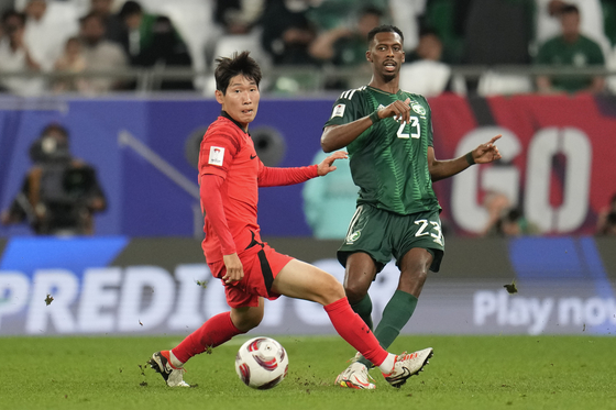 Korea's Hong Hyun-seok, left, and Saudi Arabia's Mohammed Kanno battle for the ball during the AFC Asian Cup round of 16 at Education City Stadium in Al Rayyan, Qatar on Jan. 30. [AP/YONHAP]