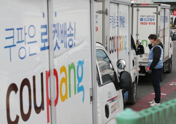 A Coupang delivery van is parked at the company's logistics center in the Seocho district. (YONHAP)