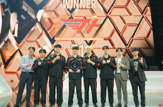 T1 beat Top Esports 3-1 to win the League of Legends tournament at the inaugural Esports World Cup in Riyadh, Saudi Arabia on Sunday and pose with the trophy in a photo shared by T1 on X. [SCREEN CAPTURE]