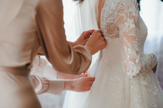 Bride dresses for her wedding [GETTY IMAGES]