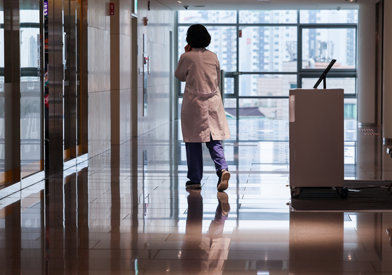A doctor walks inside a hospital in downtown Seoul on Friday. [YONHAP] 