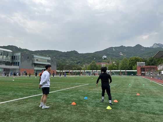 Players train on a pitch. [HOMELESS WORLD CUP]