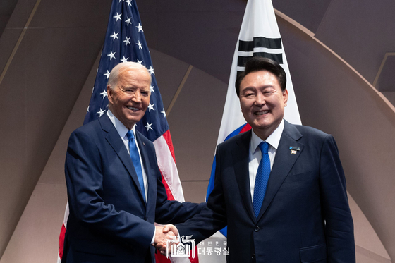 President Yoon Suk Yeol, right, and U.S. President Joe Biden shake hands during a meeting on the sidelines of the NATO summit on Washington on Thursday. [PRESIDENTIAL OFFICE]