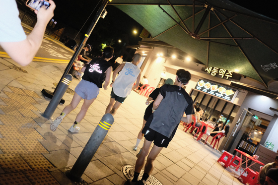 late night patrons fill the tables outside a chicken shop in a residential area of central Seoul. [HAN STRIDE]