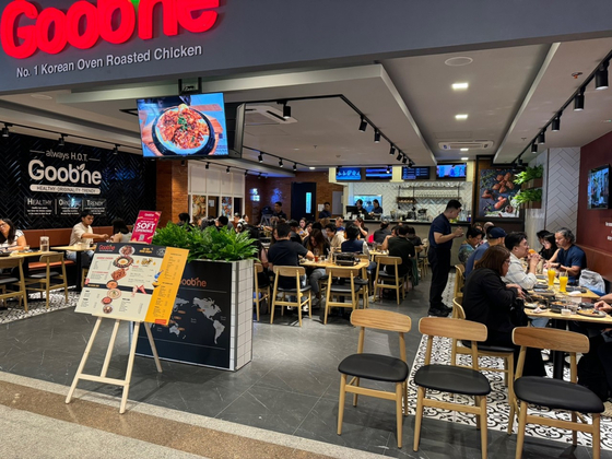 This undated photo, provided by GN Food, shows people enjoying roast chicken and side dishes at its first outlet in the Philippines. The store is located in Bonifacio Global City, a central business district in Taguig, Metro Manila. [GN FOOD]