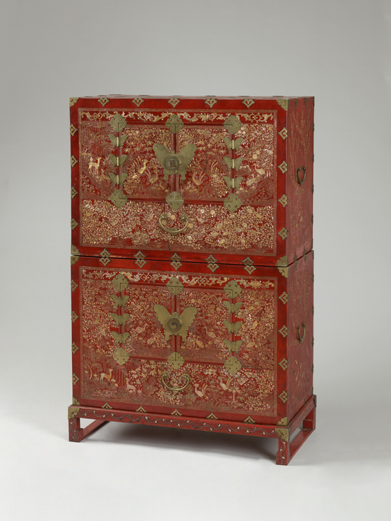 A Korean two-tiered wardrobe with 10 longevity symbols made with red lacquer and mother-of-pearl inlay from the late 19th to early 20th century [NATIONAL MUSEUM OF KOREA]