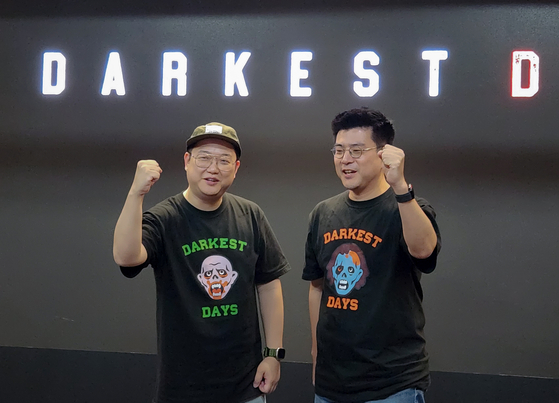 Darkest Days executive producer Kim Dong-sun, right, poses for the camera during Thursday's press event held at the NHN headquarters in Pangyo. [NHN]