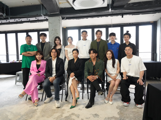 "Artainers," or entertainers who double as artists, pose for photos during a press conference for their exhibition ″bbuck on & off″ held on July 3 in Itaewon, central Seoul. [ARTVERSE]