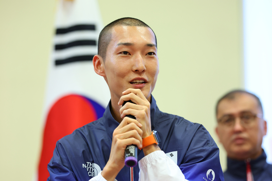 Woo Sang-hyeok speaks to reporters at the French National Defense Sports Center in Fontainebleau, France ahead of the Paris Olympics on Sunday. [JOINT PRESS CORPS]