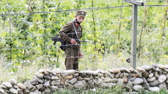 A North Korean soldier stands guard with his gun on the bank of the Yalu River in North Korea's Ryanggang Province on Sept. 25, 2020. [YONHAP]