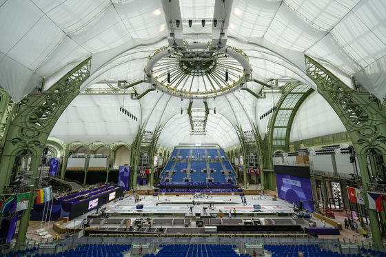 Workers apply the final touches to the Grand Palais, the venue that will host fencing and taekwondo at the Paris Olympics. [AP/YONHAP]