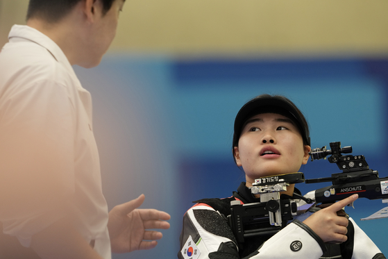 Korea's Keum Ji-hyeon is instructed by her coach as she competes for the gold medal in the 10-meter air rifle mixed team gold medal round at the 2024 Paris Olympics on Saturday in Chateauroux, France. [AP/YONHAP]