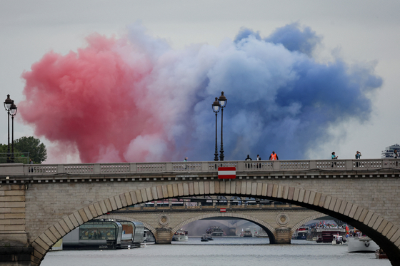Smoke clouds in the colors of the French flag are seen during the opening ceremony.  [REUTERS/YONHAP]