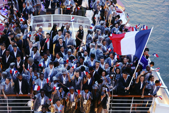 French athletes ride along the Seine during the opening ceremony for the 2024 Paris Olympics.  [AP/YONHAP]