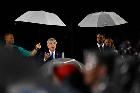 President of the International Olympic Committee Thomas Bach delivers a speech during the rainy opening ceremony of the Paris Olympics in Paris on Friday. [AFP/YONHAP]