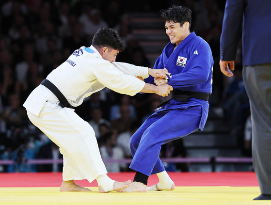 Korean judoka Kim Won-jin, right, competes in the men’s -60 kilogram repechage contest against Sardalashvili Giorgi of Georgia at the Paris Olympics at Champ-de-Mars Arena in Paris on Saturday. [JOINT PRESS CORPS] 