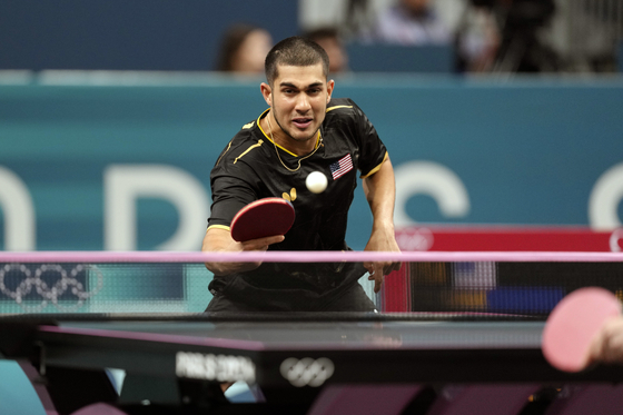 United States' Kanak Jha plays against Korea's Cho Dae-seong during a men's singles round of 64 table tennis game at the Paris Olympics on Sunday in Paris. [AP/YONHAP]
