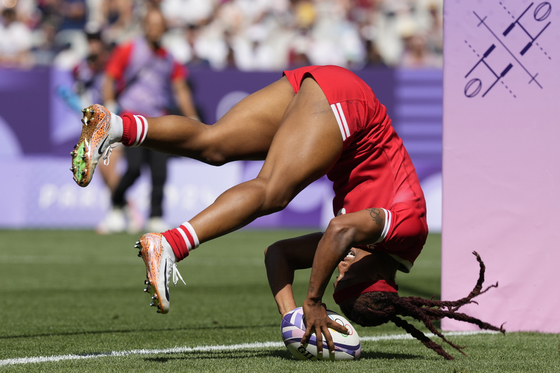 Canada's Charity Williams does a forward roll as she scores a try during a women's Pool A rugby sevens match against China at the Stade de France in Paris on Monday. [AP/YONHAP]