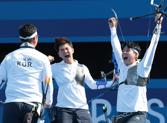 Korean archers celebrate after beating France in the men's team archery gold medal match at the 2024 Paris Olympics in Paris on Monday.  [JOINT PRESS CORPS]