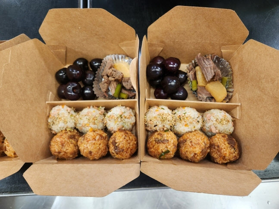 An on-the-go lunch box filled with rice balls, side dishes and fruit is provided to Korean athletes at the Paris Olympics in a photo provided by the Korean Sport & Olympic Committee. [YONHAP]