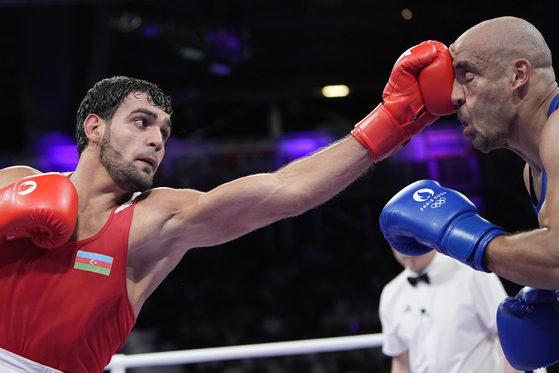 Azerbaijan's Murad Allahverdiyev, left, fights Egypt's Abdelrahman Abdelgawwad in their preliminary men's 80-kilogram boxing match at the Paris Olympics in Paris on Tuesday. [AP/YONHAP]
