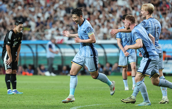 Tottenham Hotspur captain Son Heung-min, center, celebrates scoring a goal during a Coupang Play Series match against Team K League at Seoul World Cup Stadium in western Seoul on Wednesday. [NEWS1]