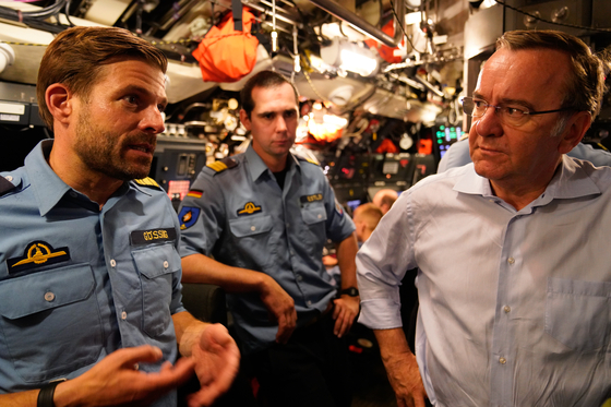 German Defense Minister Boris Pistorius, right, speaks with the commander of the 1st Submarine Squadron, Frigate Captain Lars Goring, on board submarine U-31 during his visit to the German Navy in Eckernforde Bay on July 19, 2024. [EMBASSY OF GERMANY]