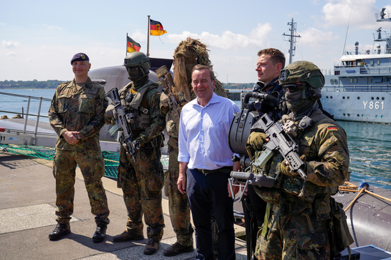 German Defense Minister Boris Pistorius, center, accompanied by the commander of the Sea Battalion, Frigate Captain Patrick Steinbach, poses with soldiers for a group photo at the naval base during his visit to the Navy troops in Eckernforde on July 19, 2024. [EMBASSY OF GERMANY]