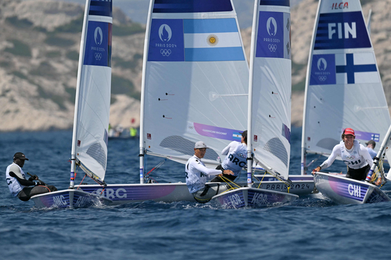 Korea's Ha Jee-min, second from right, competes in Race 4 of the men's dinghy at Paris Olympics in Marseille on Friday. [AFP/YONHAP]