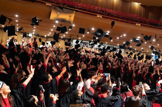 Students throw their hats in the air during the International Summer Campus program's certification ceremony on Thursday. [KOREA UNIVERSITY]