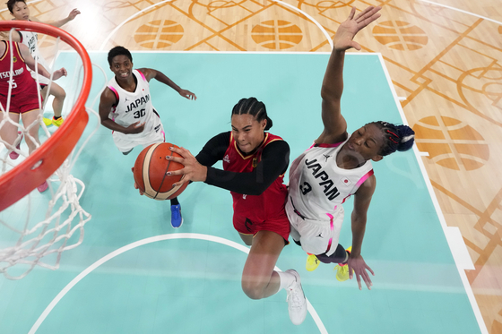 Germany's Satou Sabally, center, shoots as Japan's Stephanie Mawuli, right, defends and Japan's Evelyn Mawuli watches in a women's basketball game at the Paris Olympics on Thursday in Villeneuve-d'Ascq, France. [AP/YONHAP]
